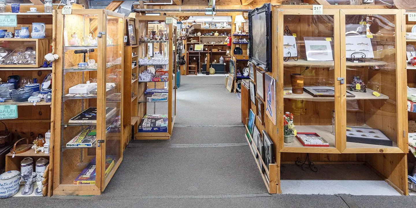Wooden display cases and booths under an Antique Malls sign